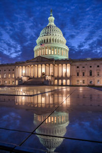 Reflection of building in water at night