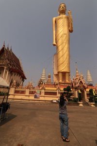 Statue of temple against building