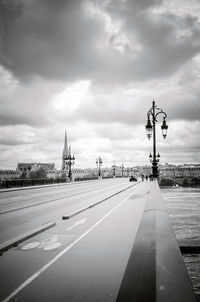 Pont de pierre bridge over river against cloudy sky