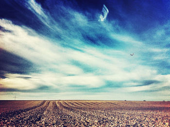 Scenic view of landscape against cloudy sky