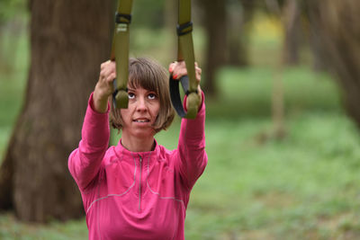Mid adult woman exercising at public park