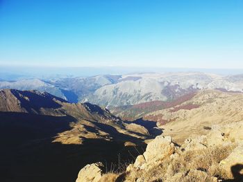 Scenic view of dramatic landscape against clear blue sky