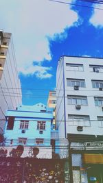 Low angle view of modern building against blue sky