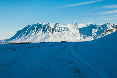 Scenic view of snowcapped mountains against blue sky