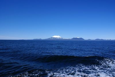 Scenic view of sea against clear blue sky