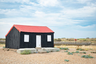 Built structure on beach against sky