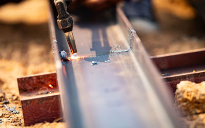 Metalworker wields torch with caution cutting through steel. sparks fly as craftsman demonstrates