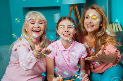 Happy family playing with bubbles at home