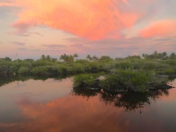 Scenic view of lake against sky at sunset