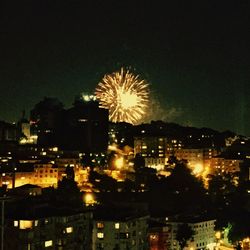 Firework display in city at night