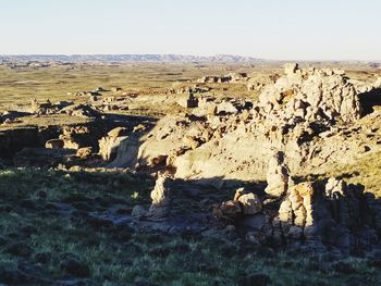 Panoramic shot of rocks on land against clear sky