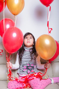 High angle view of girl holding balloons