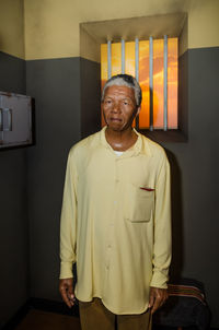 Portrait of smiling man standing at home