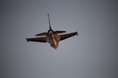 Low angle view of airplane flying against clear sky