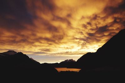 Scenic view of mountains against cloudy sky