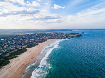 High angle view of sea and buildings against sky