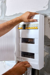 Cropped hand of man working at home