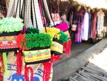 Close-up of multi colored flags hanging at market stall