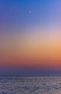 Scenic view of sea against clear sky at sunset