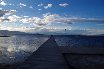 Empty jetty leading to calm sea