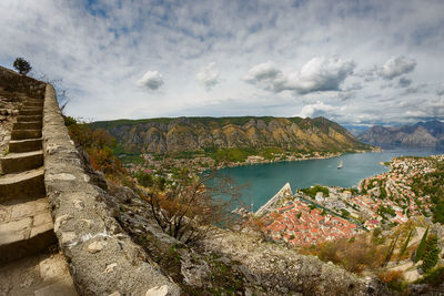 Scenic view of river by mountains against sky