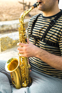 Midsection of man playing piano