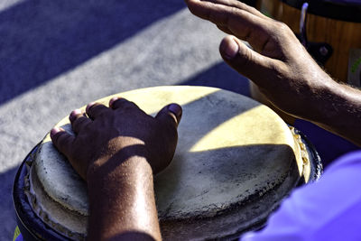 Cropped hands of person playing musical instrument