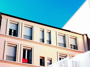 Low angle view of building against clear blue sky