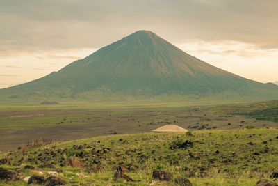 Scenic view of mount ol doinyo lengai against blue sky in the ngorongoro conservation area, tanzania