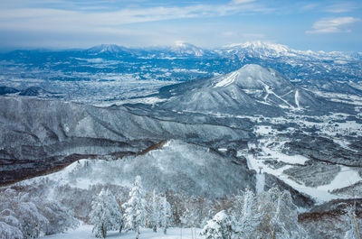 High angle view of snowcapped mountains against sky