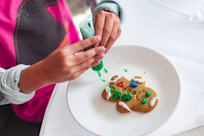 High angle view of hand holding ice cream in plate