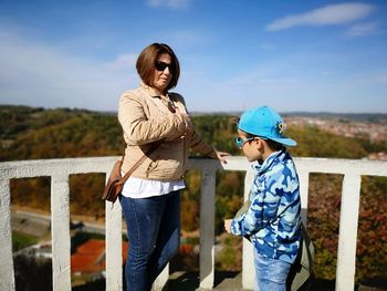 Mother with son standing at observation point