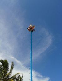 Low angle view of trees against blue sky