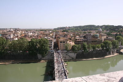 River amidst buildings against clear sky