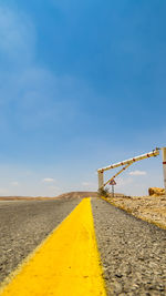 Surface level of road against blue sky