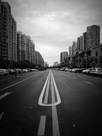 View of city street and buildings against sky