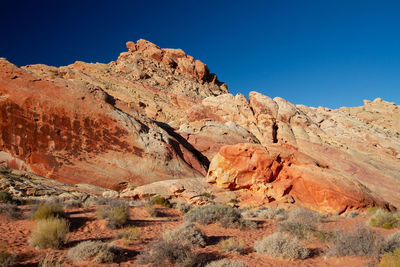 Scenic view of rocky mountains against clear blue sky