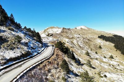 Mountain road against clear blue sky