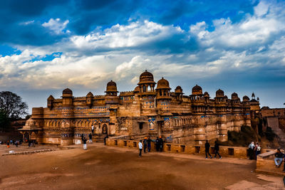 People standing by historic building