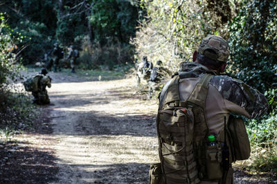 Rear view of soldiers at forest