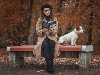 Full length of man with dog on bench