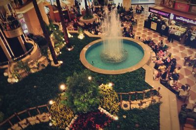 High angle view of people at swimming pool at night