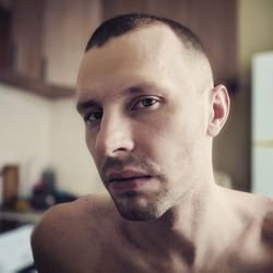 Close-up portrait of shirtless young man