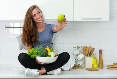 Young woman preparing food in kitchen at home
