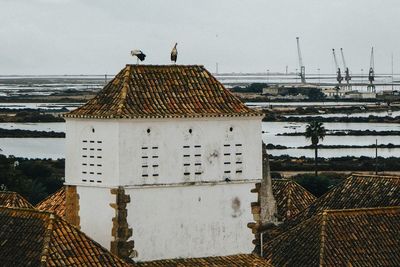 View of building by sea against sky