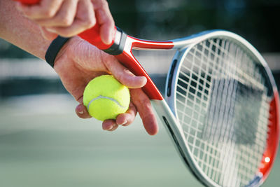 Cropped hand holding tennis