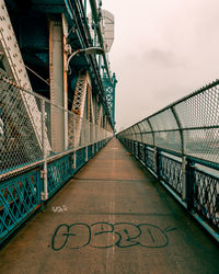 Bridge over footbridge against sky
