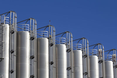 Low angle view of industry against clear sky