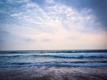 Scenic view of sea against cloudy sky