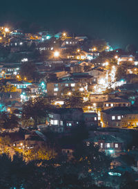 High angle view of illuminated buildings in city at night